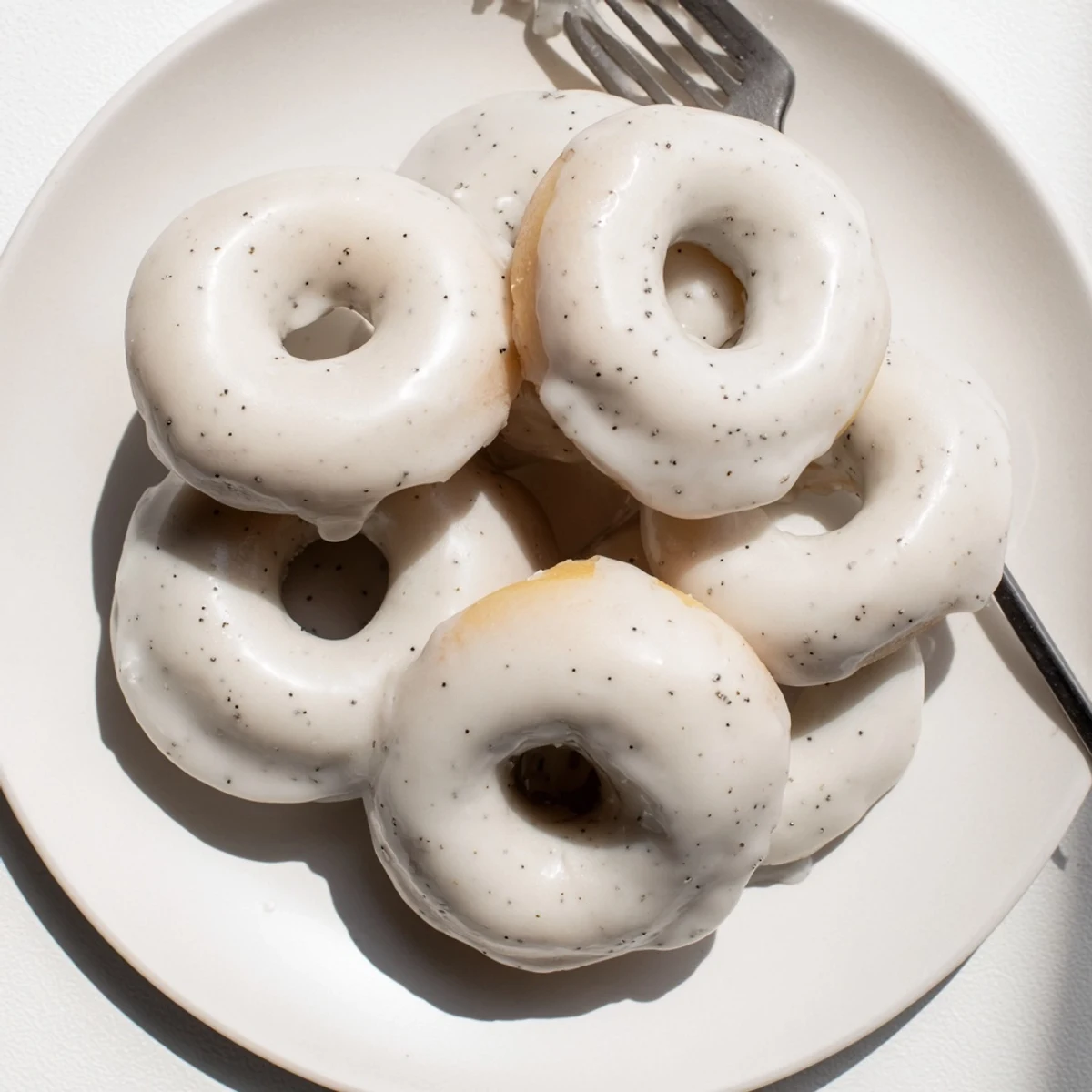 Chewy tea-infused donuts arranged on wire rack with glossy Earl Grey glaze topping