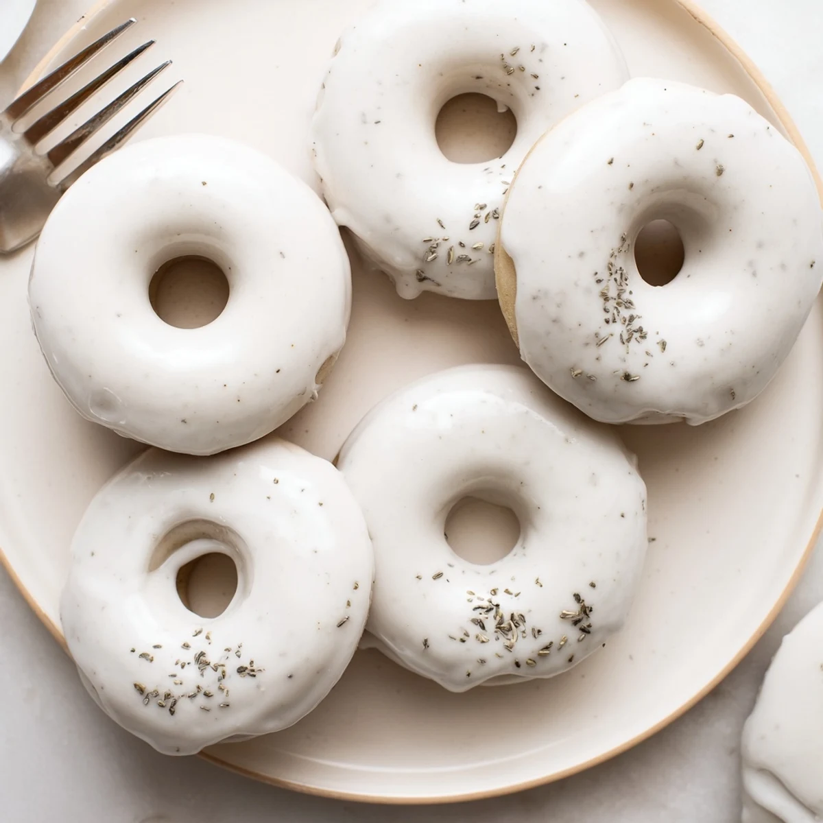 Fragrant Earl Grey mochi donuts displaying signature bouncy texture and glaze drips on white plate