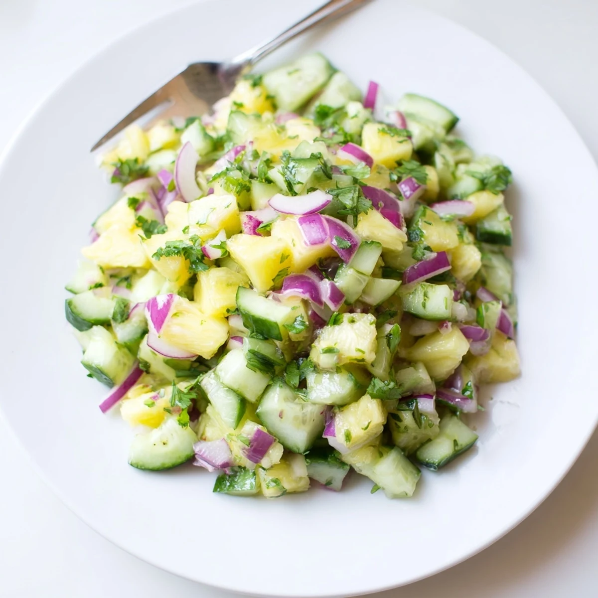 Refreshing pineapple cucumber salad bowl showcasing juicy produce with lime vinaigrette for summer gatherings