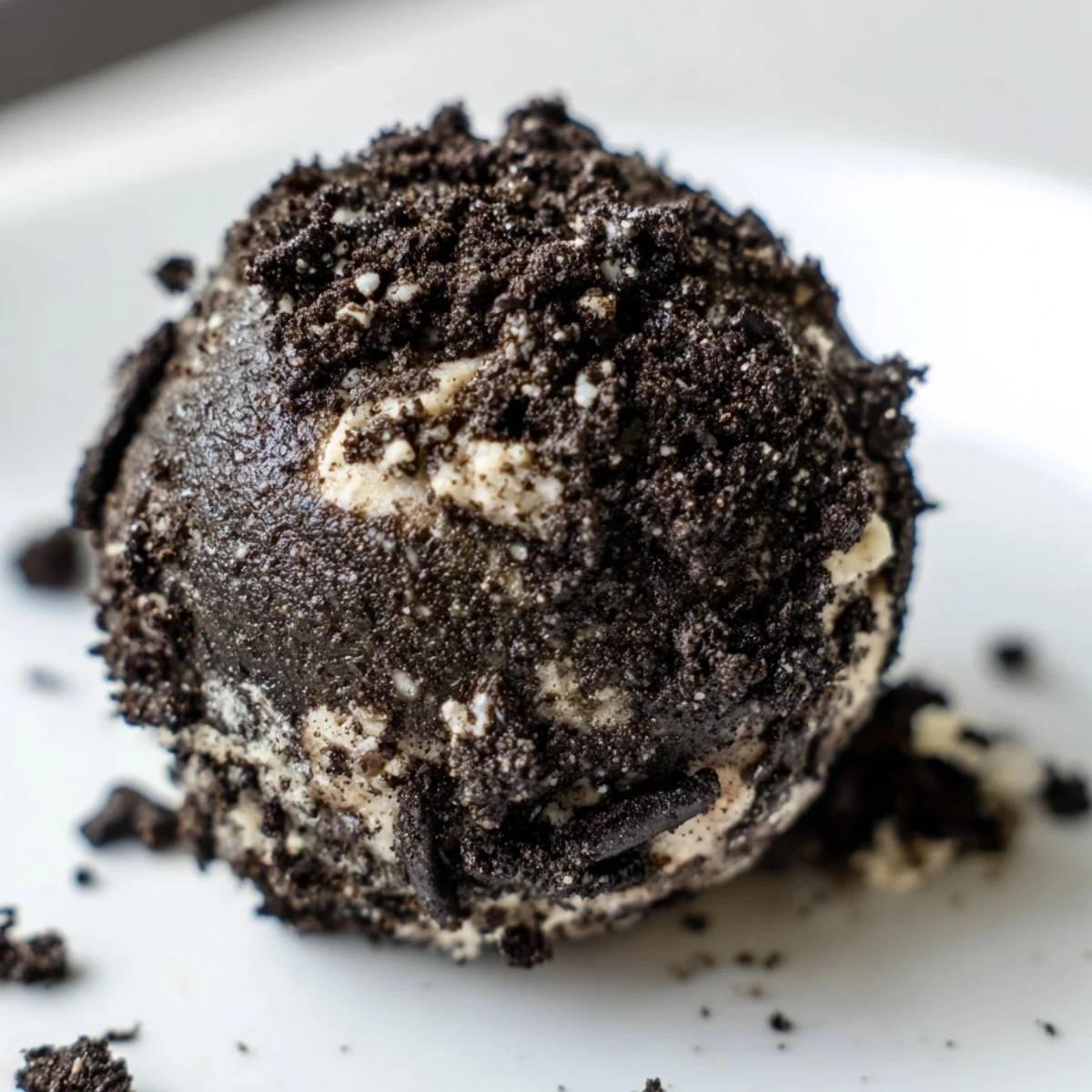 No-bake protein balls featuring crushed Oreos and cream cheese coated in chocolate cookie dust