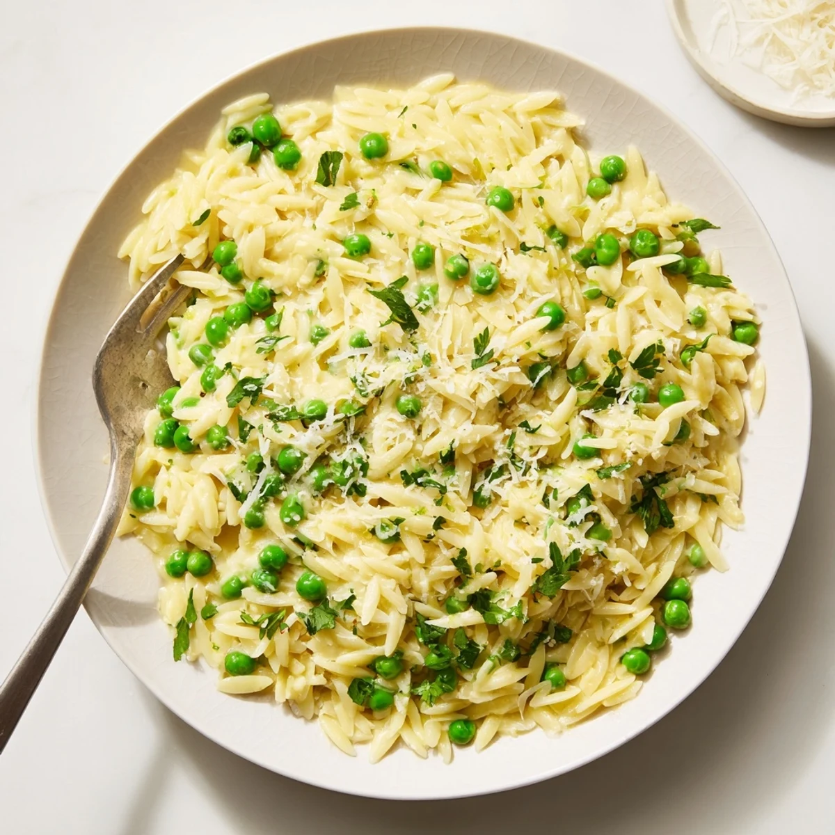 Tender orzo tossed with bright lemon zest, butter, olive oil, and fragrant green herbs