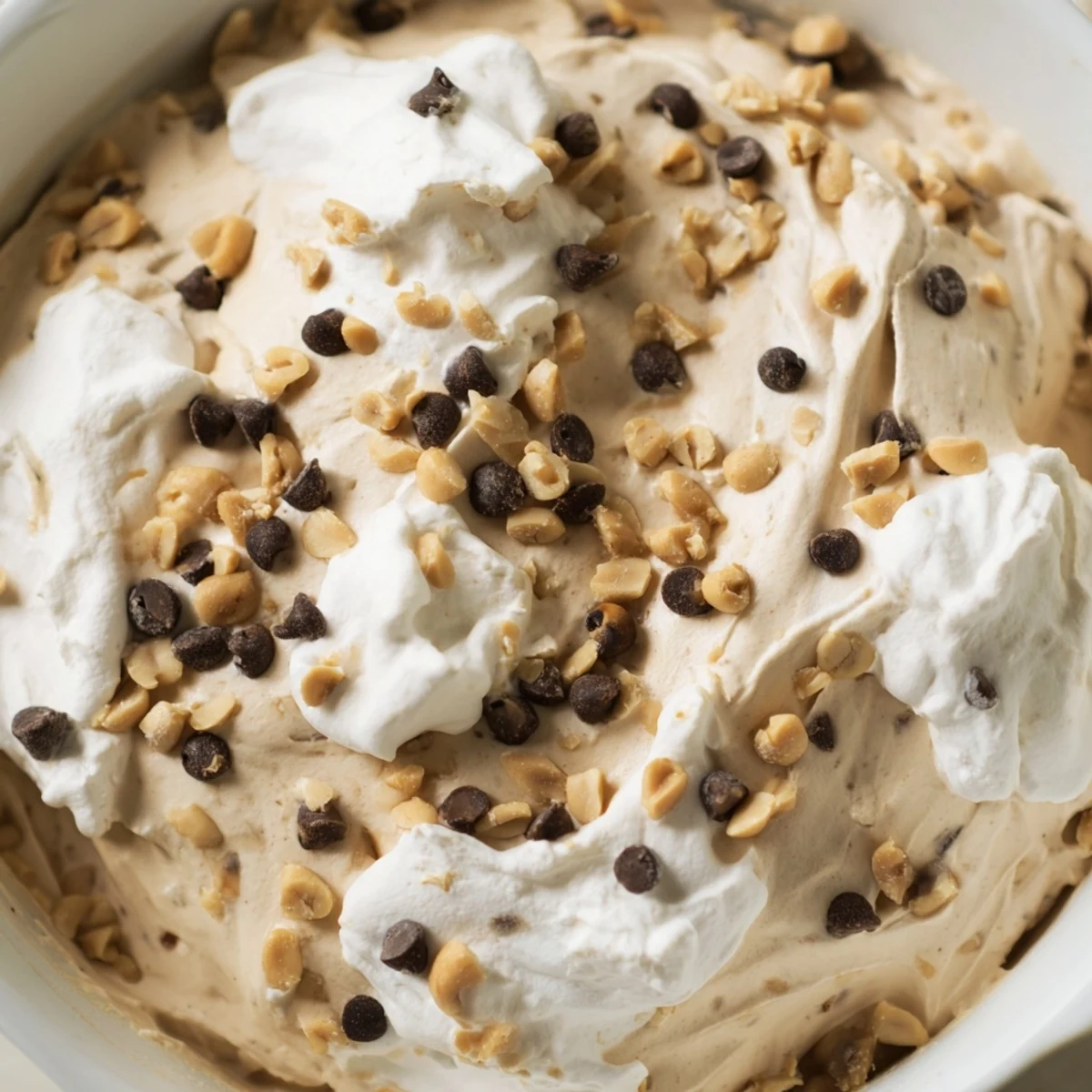 Velvety peanut butter and Cool Whip mousse served chilled in elegant dessert bowls with a sprinkle of chocolate chips