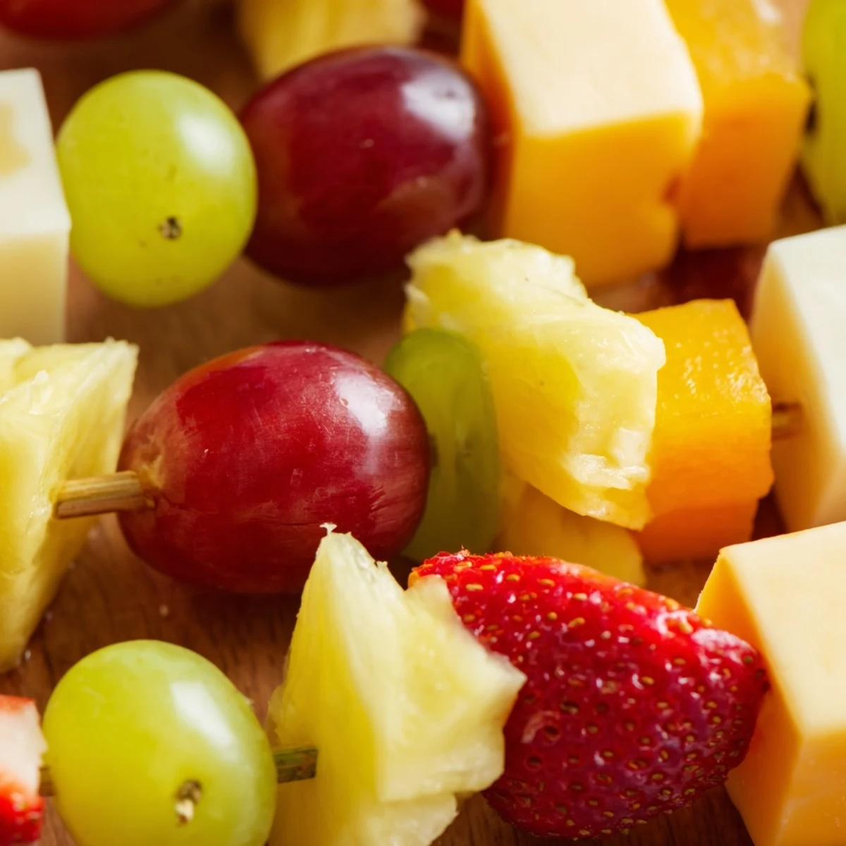 Fresh fruit and cheese kabobs featuring juicy pineapple, red grapes, and creamy Monterey Jack