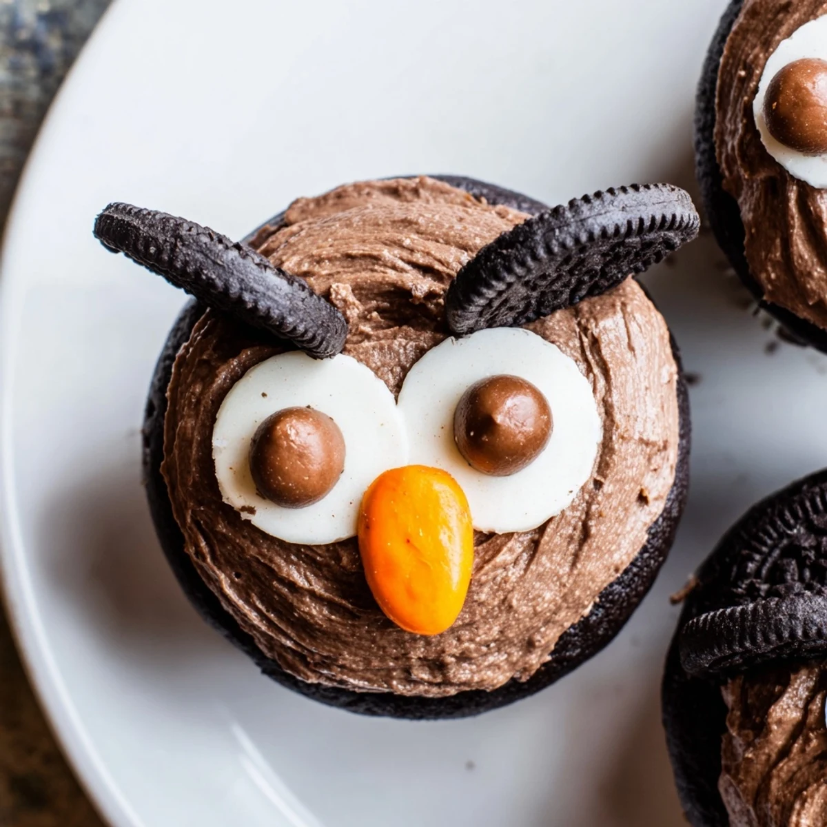 Adorable Oreo Owl Cupcakes topped with creamy chocolate frosting and playful cookie eyes