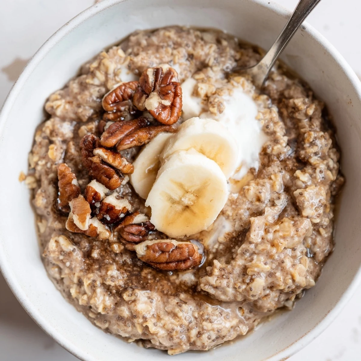 Creamy Brown Sugar Coffee Overnight Oats topped with banana and toasted pecans