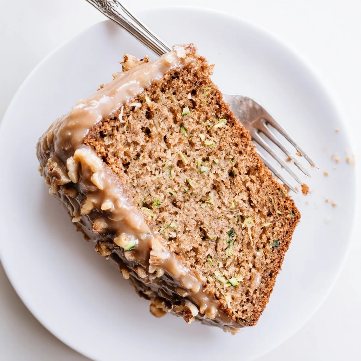 Zucchini Cake With Brown Sugar Icing, moist slices on a rustic plate