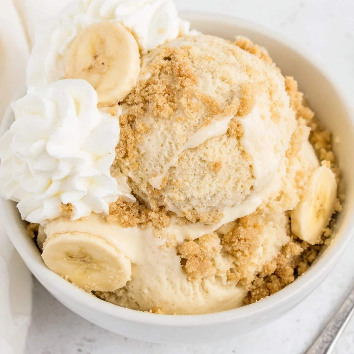Ninja Creami Banana Cream Pie Ice Cream in bowls with whipped cream  
