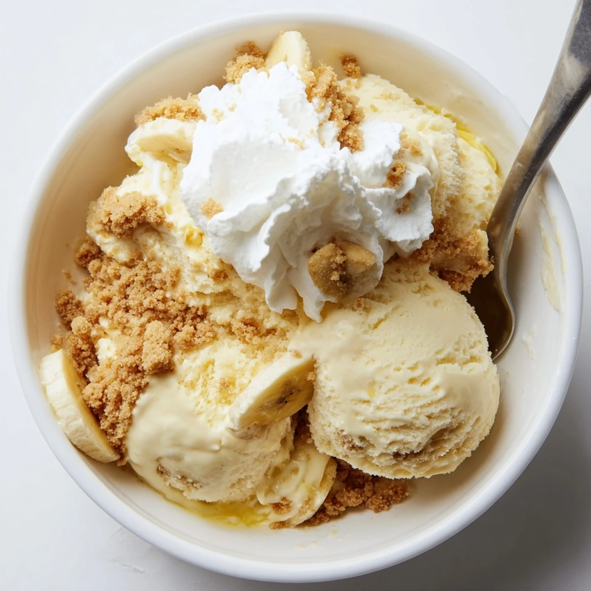 Scoops of Ninja Creami Banana Cream Pie Ice Cream topped with sliced bananas
