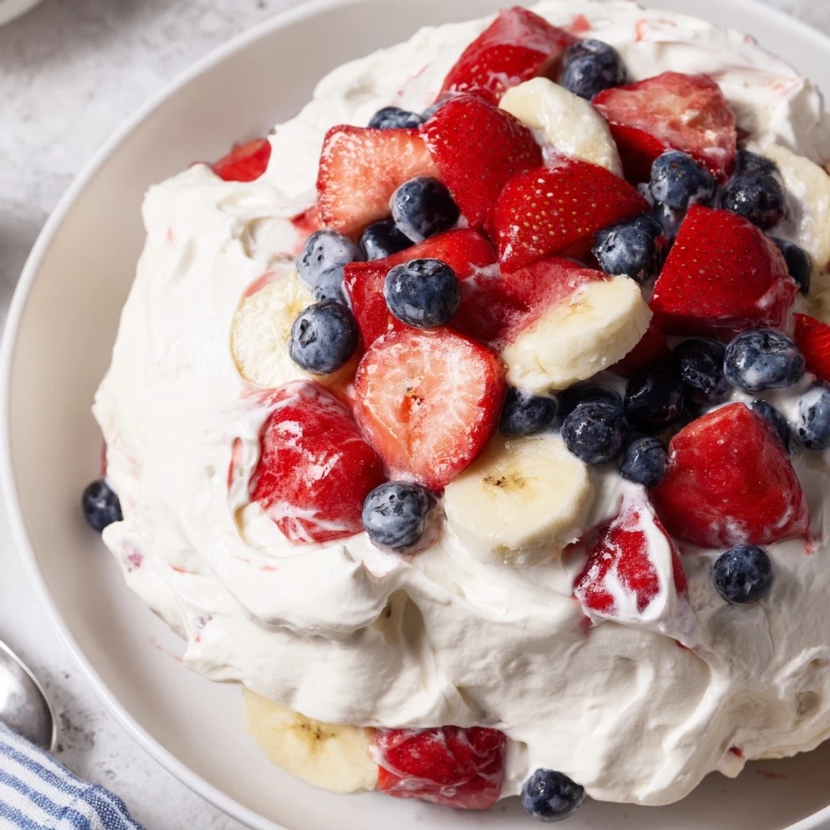 Red White And Blue Cheesecake Salad with creamy filling and chilled juicy berries
