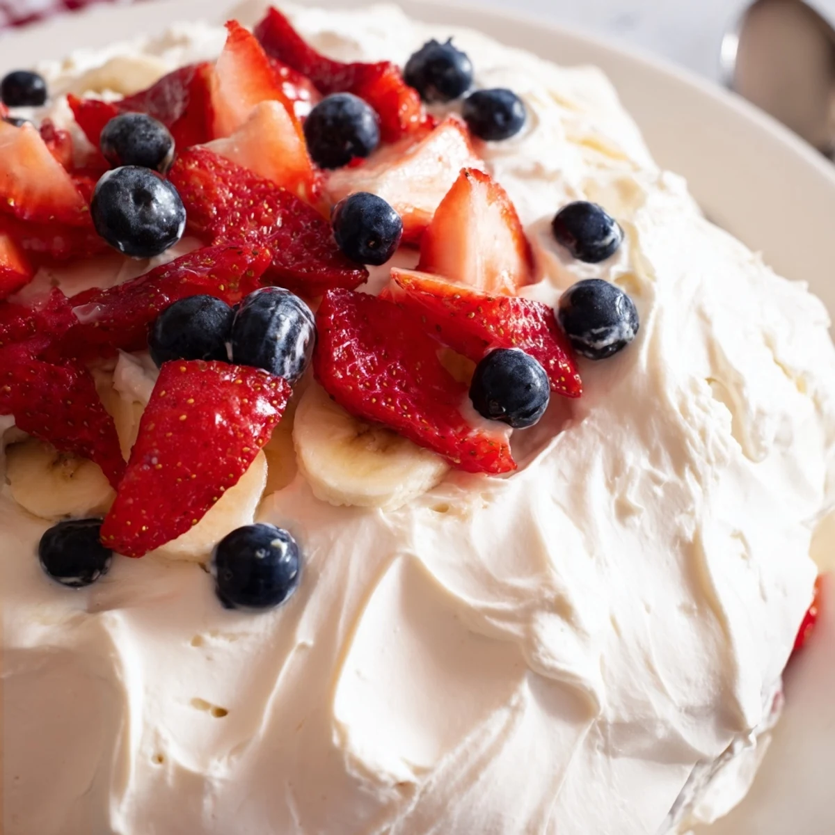 Festive Red White And Blue Cheesecake Salad served cold, garnished with extra berries