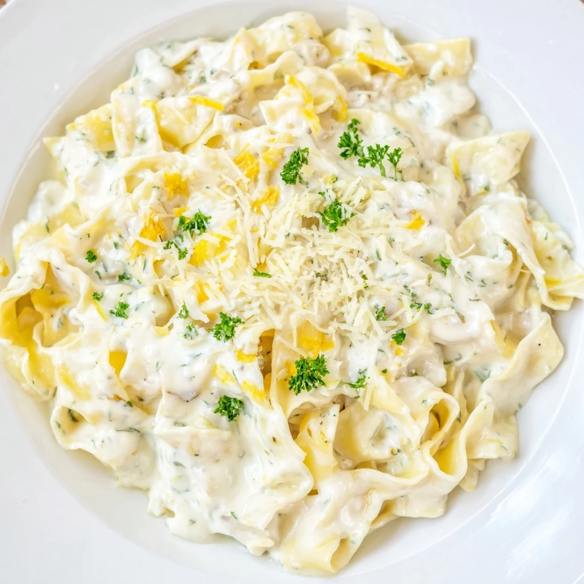 Comforting bowl of creamy cafeteria noodles featuring tender egg noodles coated in savory white sauce