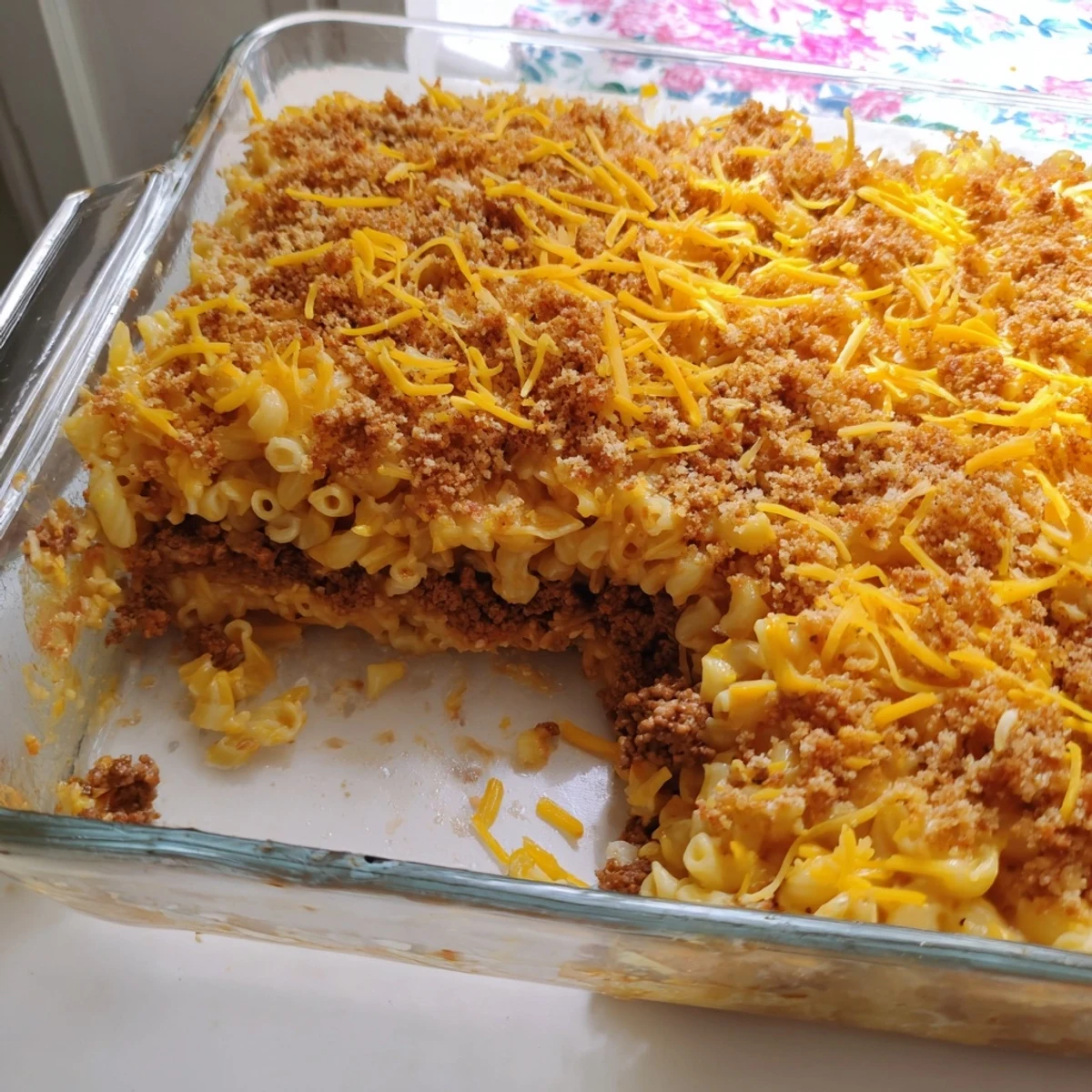 Savory meatloaf base layered beneath creamy macaroni and cheese in this hearty American comfort casserole
