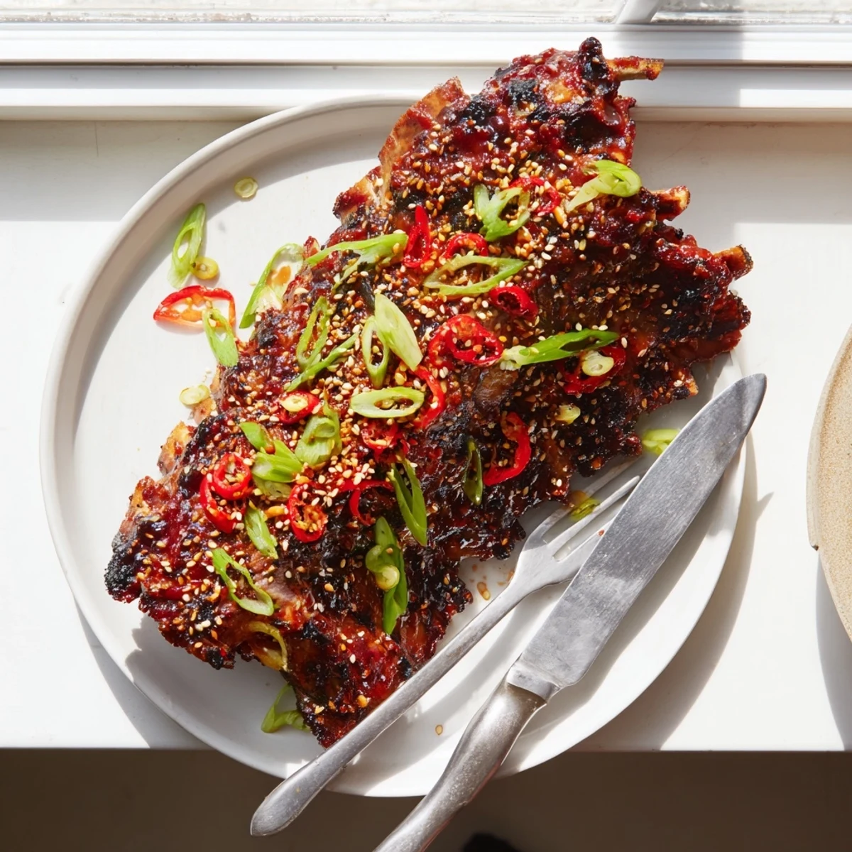 Caramelized Korean BBQ lamb ribs glazed and finished with bright yuzu citrus