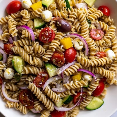 Creamy mozzarella and vibrant bell peppers crown this chilled vegetarian Italian pasta salad